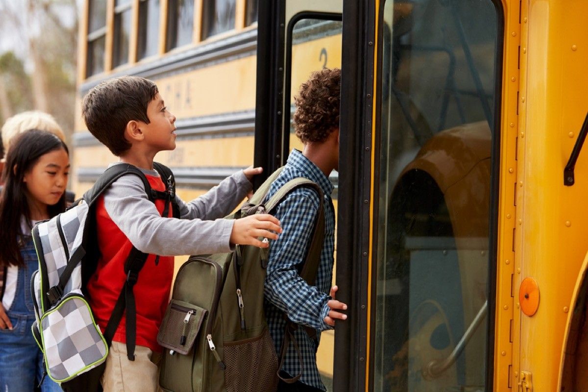 kids getting on a school bus